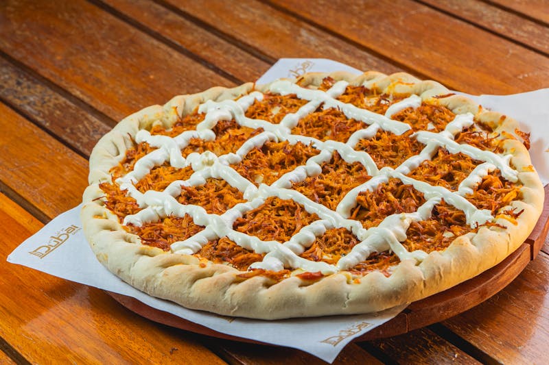 BBQ chicken via 313 pizza with smoky sauce, grilled chicken, and red onion