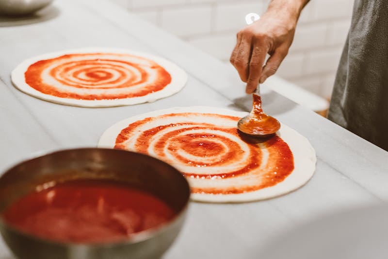 Via 313 dough master hand-stretching fresh pizza dough for Detroit-style pies